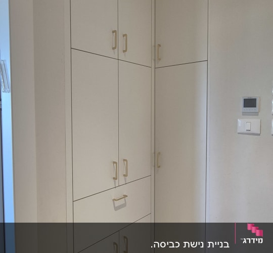 ארון קיר עם דלתות לבנות וידיות זהב